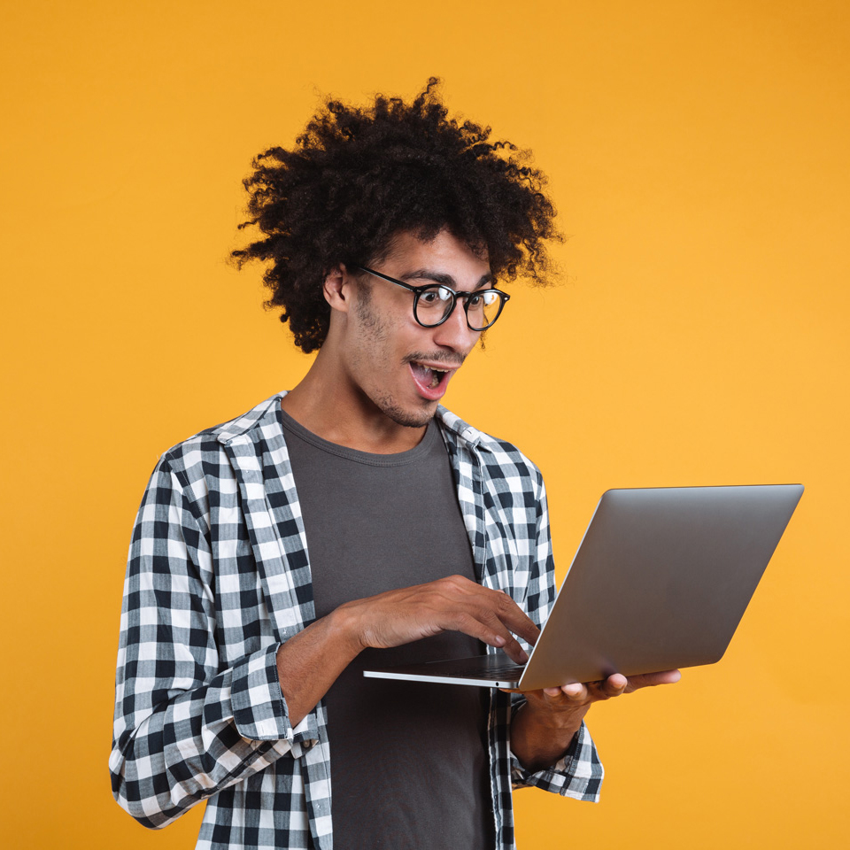 Portrait of an excited young african man in eyeglasses